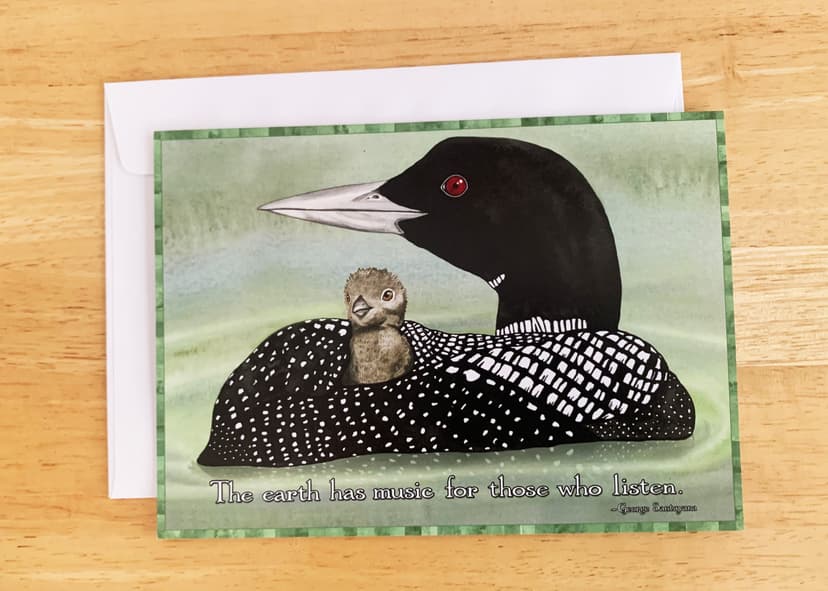 Mother loon with baby loon on her back, sweet for nature lovers and moms