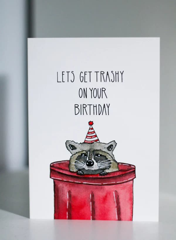 Funny raccoon birthday card by Courtney Andrews with 'Let's Get Trashy'—great for the jokester in your life.